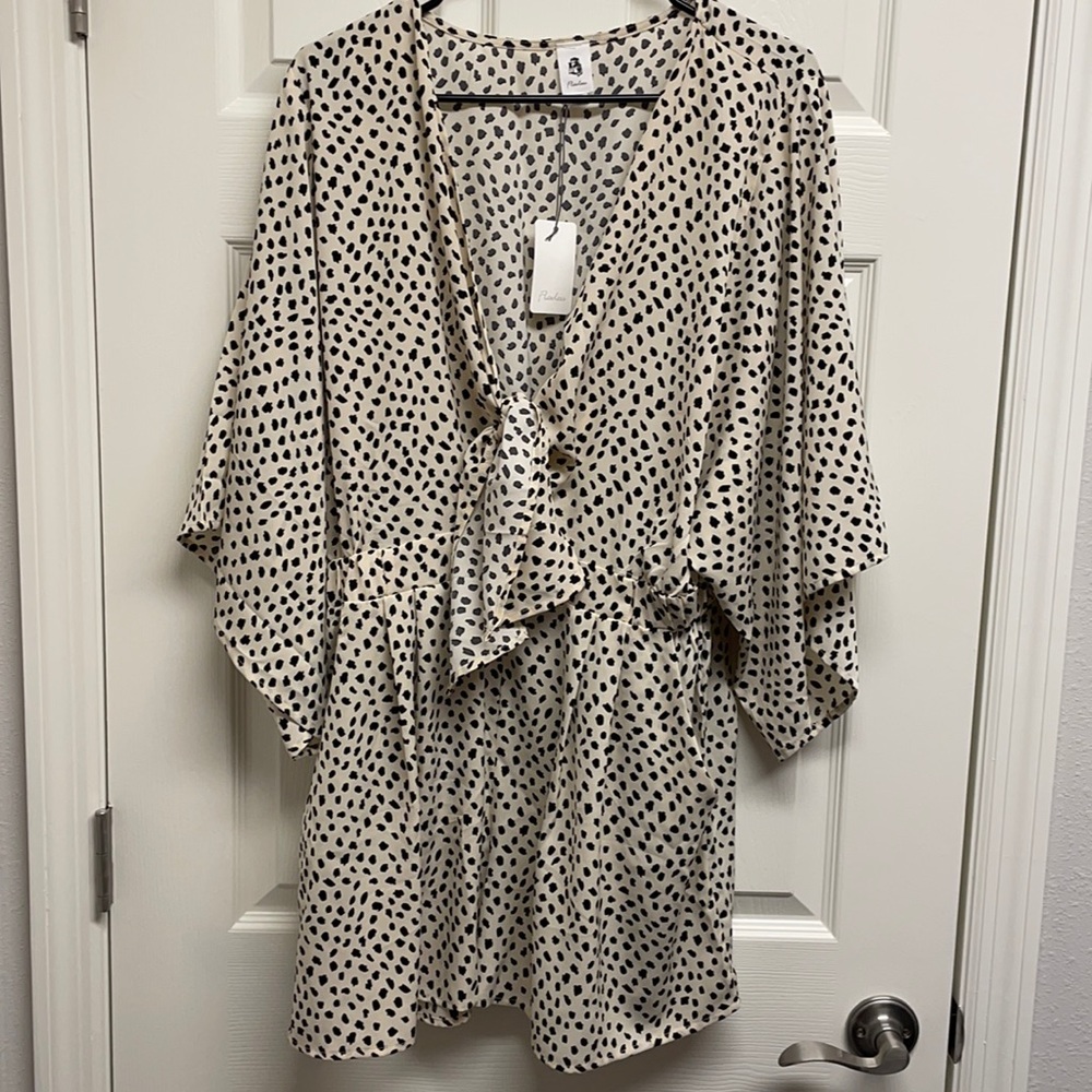 Kimono sleeved romper with keyhole tie in front.